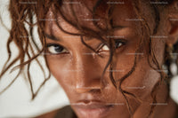 Close-up Portrait of a Woman with Curly Hair and Glistening Skin