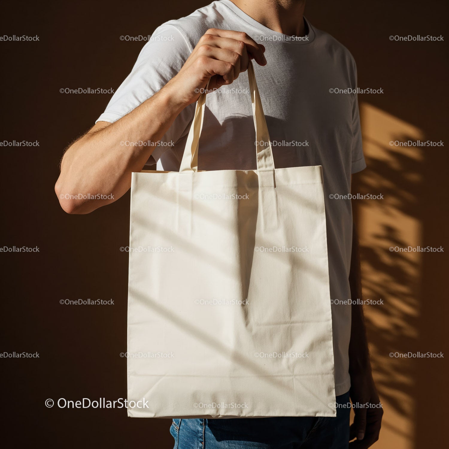 Man Holding Blank Canvas Tote Bag on Brown Background