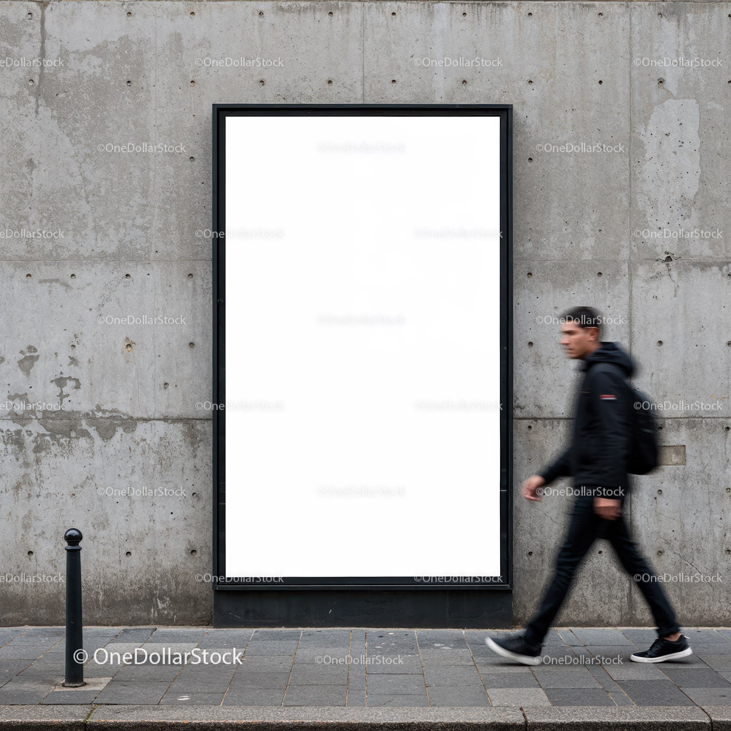 Man walking past blank urban billboard on concrete wall