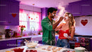 Couple Playfully Baking Heart Cookies in Bright Kitchen