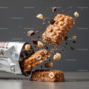 Chocolate Peanut Protein Bar Breaking with Falling Nuts