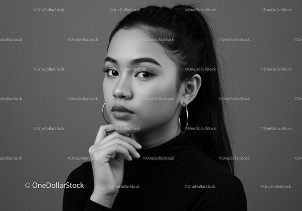 Elegant Black and White Portrait of a Young Woman with Hoop Earrings
