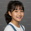 Smiling Asian Girl with Braces Wearing Denim Overalls and White T-Shirt