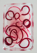 Red onion slices frozen inside a clear ice block