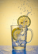 Refreshing splash of lemon water with ice cubes