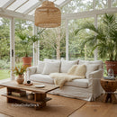 Cozy sunlit living room with natural decor and greenery