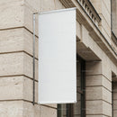 Blank white banner hanging on classic stone building