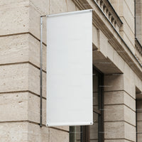 Blank white banner hanging on classic stone building