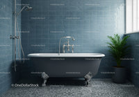 Classic clawfoot bathtub in modern blue tiled bathroom