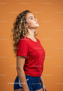 Young woman with curly hair looking upward in studio