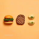 Gourmet Burger with Lettuce and Tomato Next to Grilled Steak and Dumpling