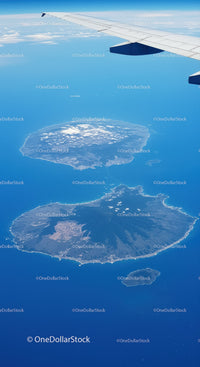 Aerial View of Volcanoes and Islands Below from an Airplane Window