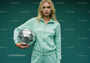 Young Woman in Mint Green Tracksuit Holding Disco Ball in Studio
