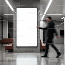 Blurred man walking past empty advertising board indoors