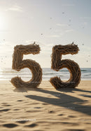 Number Fifty Five made of driftwood on sandy beach