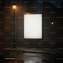 Empty illuminated billboard on quiet rainy street at night