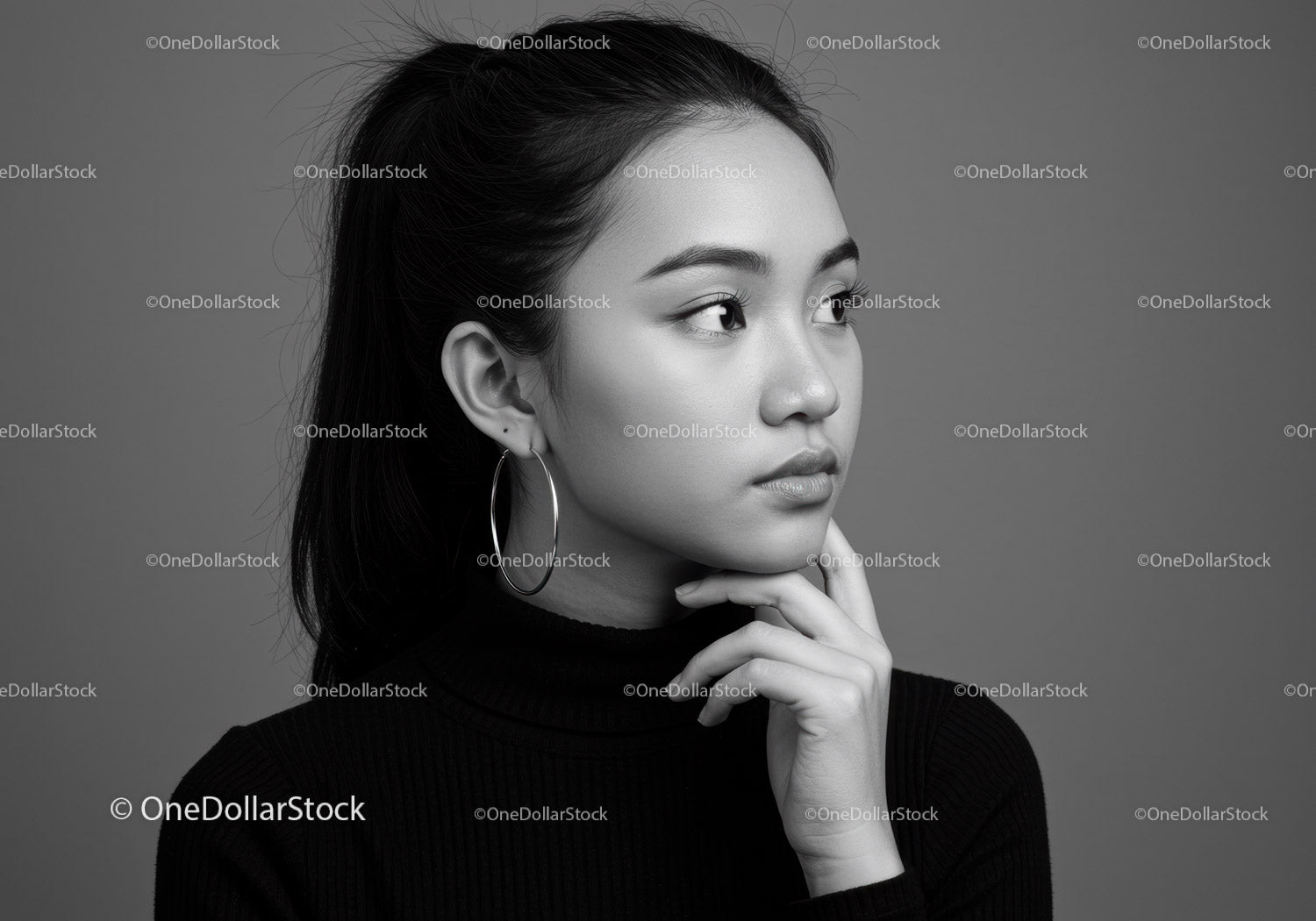 Elegancki monochromatyczny portret młodej kobiety z kolczykami w kształcie kółek