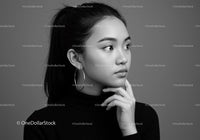 Elegant Monochrome Portrait of a Young Woman with Hoop Earrings