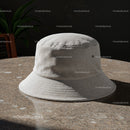 Minimalist beige bucket hat on textured stone table