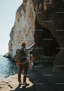 Group of Hikers Exploring Coastal Rocky Cliffs During Adventure Trip