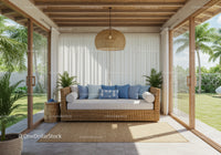 Cozy rattan sofa with blue cushions in sunlit patio