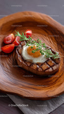 Juicy Grilled Steak with Egg Garnish on Wooden Plate