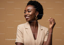 Elegant African American Woman Smiling in Beige Blazer with Jewelry