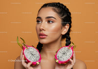 Young Woman Holding Halved Dragon Fruits with Vibrant Background