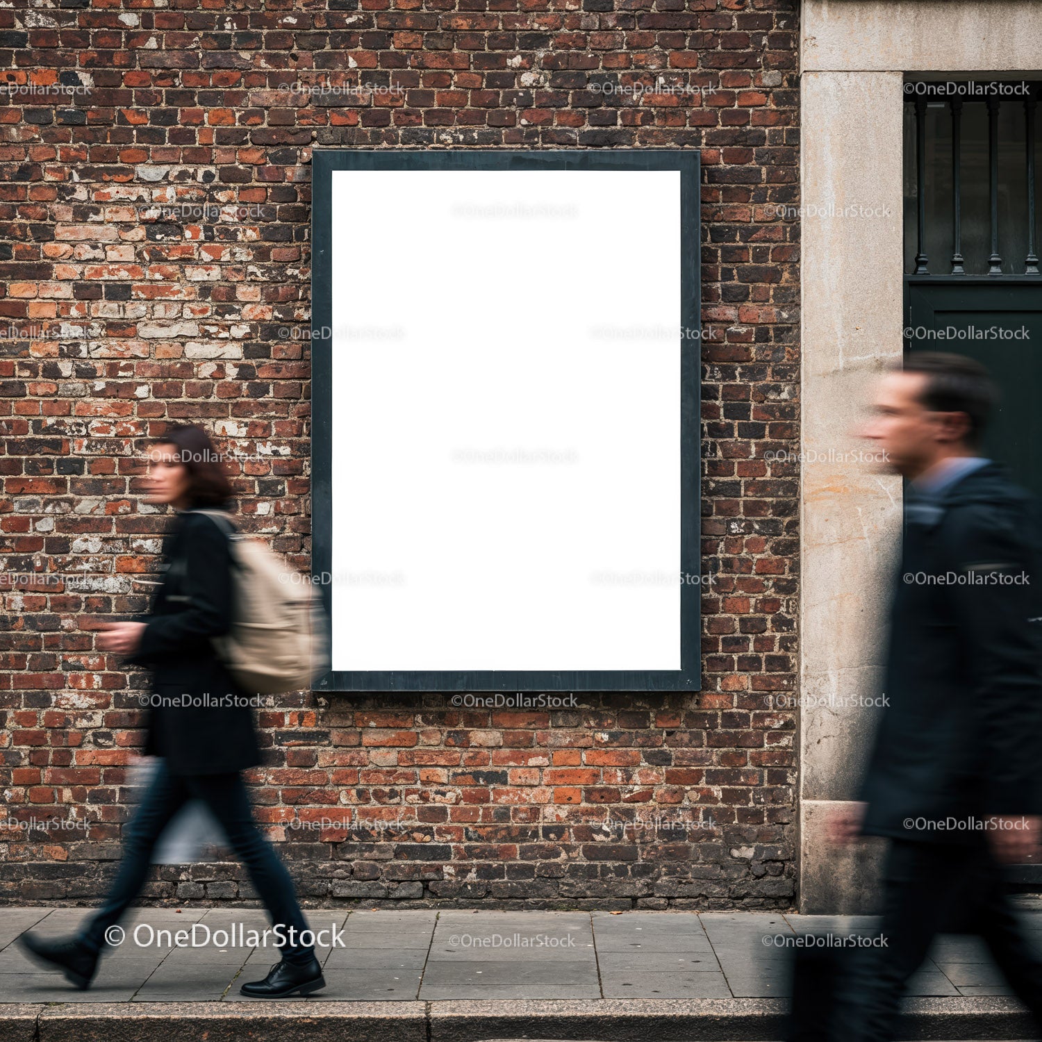 Empty white billboard on brick wall with passing pedestrians
