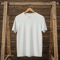Plain white t-shirt hanging on rustic wooden rack