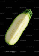 Fresh green zucchini half isolated on black background