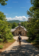 Woman Hiking Toward Small Stone Chapel in Forest With Mountain View
