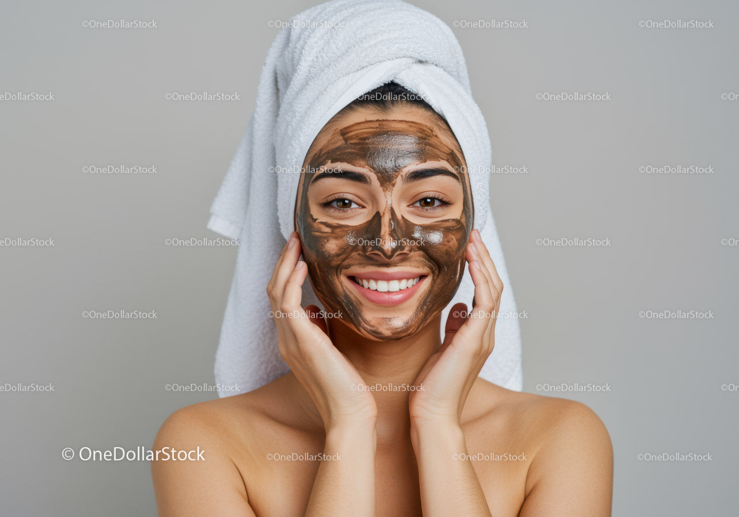 Young Woman with Mud Facial Mask Smiling During Spa Treatment