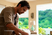 Focused man engaging in creative work at home