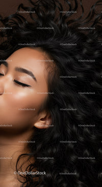 Serene woman with closed eyes and voluminous curly hair