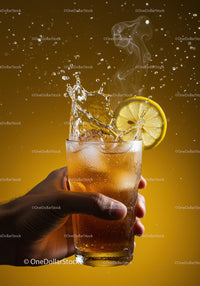 Refreshing iced tea with lemon splash in hand