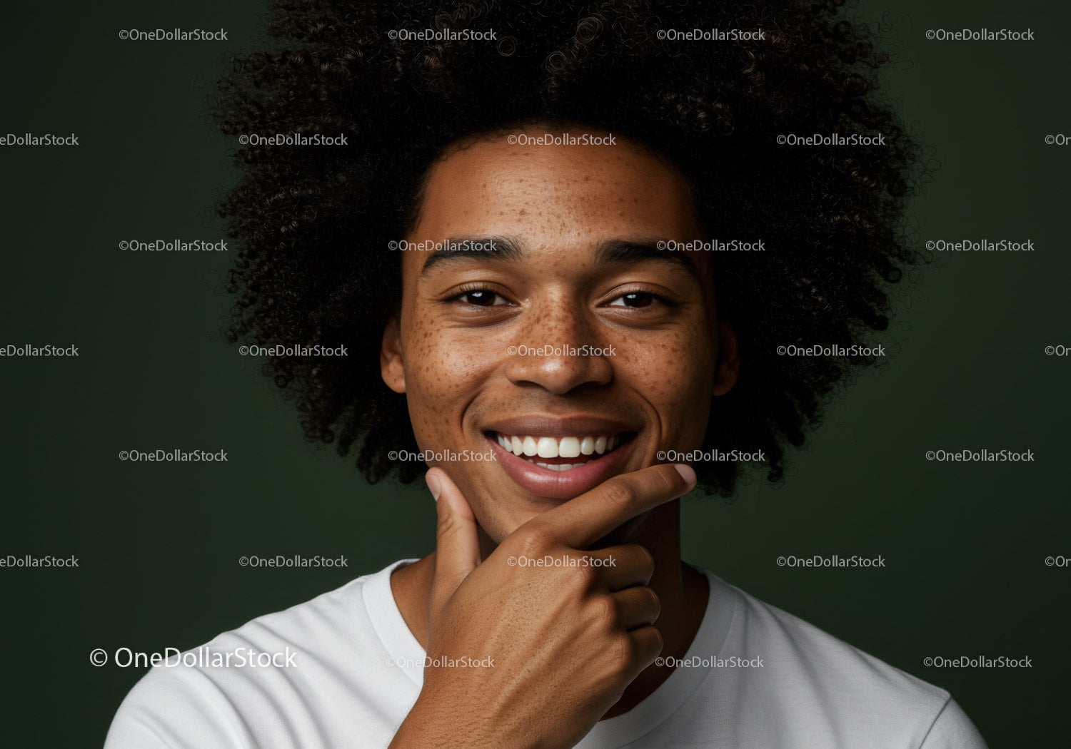 Portrait of Smiling Woman with Afro Hair and Freckles Against Green Background