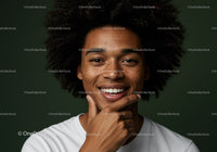 Portrait of Smiling Woman with Afro Hair and Freckles Against Green Background
