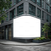 Blank illuminated billboard on modern urban street corner