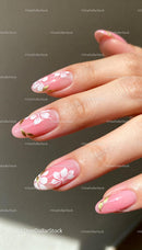 Elegant pink nails with delicate white floral design