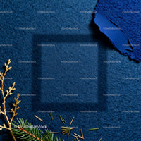 Cozy shadows on textured blue fabric with pine twigs