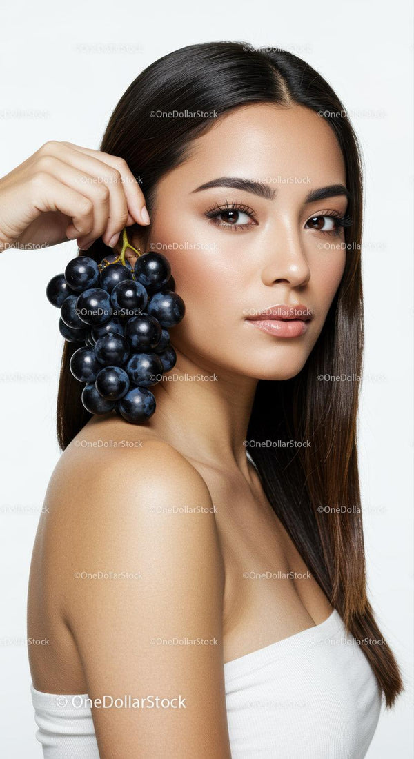 Elegant Woman Holding Bunch of Black Grapes Perfect for Beauty and Wellness