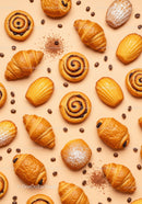 Fresh assorted pastries with coffee beans on beige background