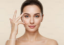 Close-up of a young woman with flawless skin demonstrating facial massage