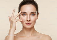 Close-up of a young woman with flawless skin demonstrating facial massage