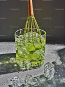 Refreshing green matcha tea with ice cubes in glass