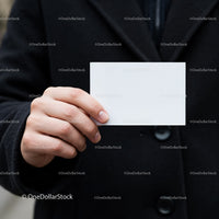 Person Holding Blank White Business Card in Black Coat