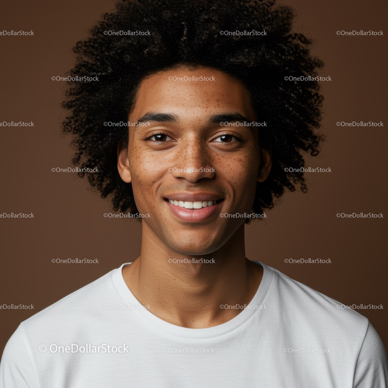 Portrait of a Smiling Man with Curly Hair and Freckles in Warm Lighting