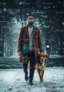 Man walking his dog on snowy forest path