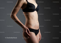 Elegant Woman in Black Lingerie Standing in Studio with Gray Background